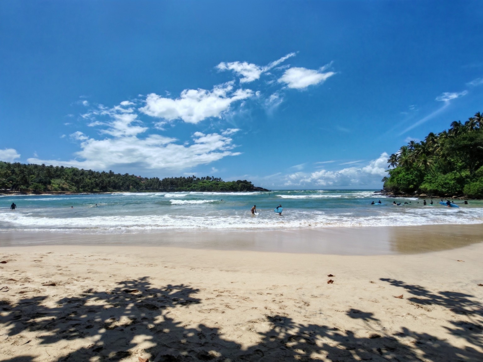 Hiriketiya Beach and surfers