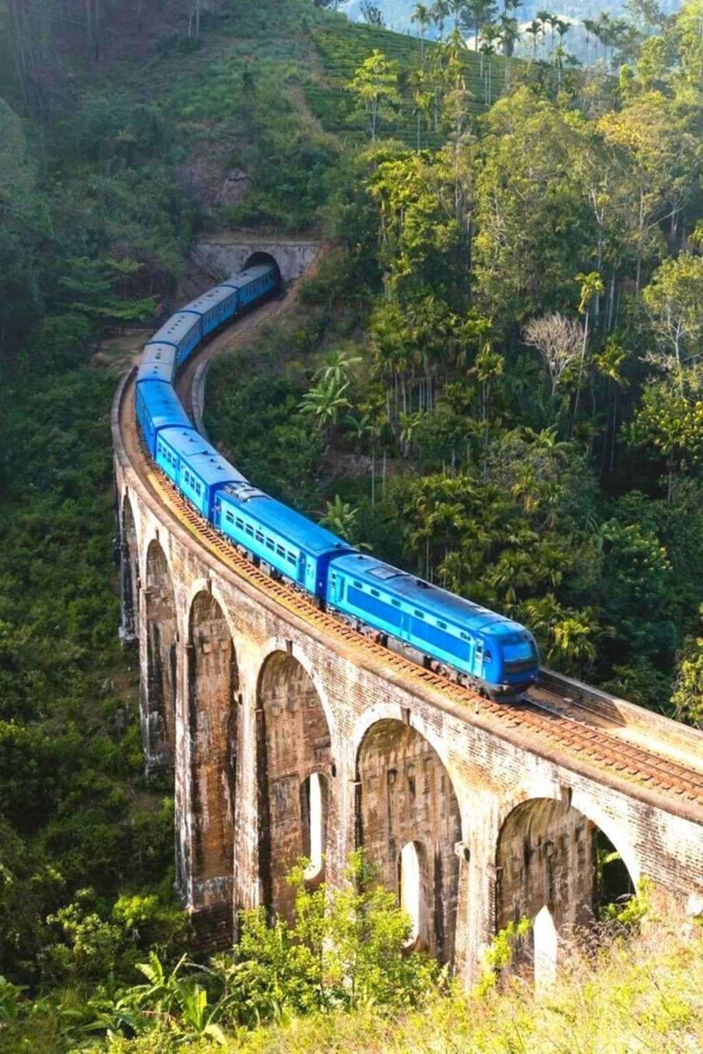 Blue train travelling through Sri Lanka hill country